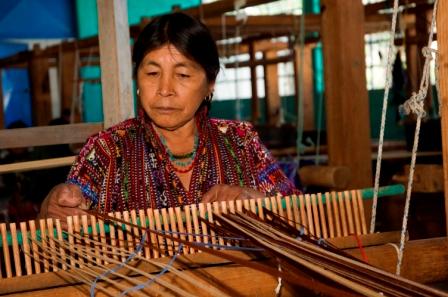 Eulalia Saloj Guitz, from the Chaquijya Cooperative in Sololá, prepares her loom to weave.